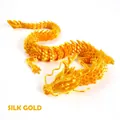 Detailed macro view of a 3D printed articulated dragon in silk gold finish with scales - 30CM Silk Gold