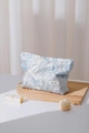 Detail of embossed floral jacquard makeup bag on a tray with cosmetics and candle - Blue Floral Large