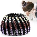 Detail showing retractable bird nest hair ring with gradient purple and pink rhinestones - Rhinestone Violet
