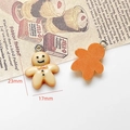 Macro detail of gingerbread man resin charms showing 23x17mm size for DIY jewelry - Gingerbread Man