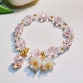Pink crystal bead bracelet with white lily of the valley charms and golden metal accents - Pink Lily Of The Valley Bracelet Sz180