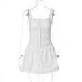 Detail of white slim fit mini dress with drawstring ruching and decorative buttons - S / White