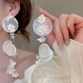 Detail showing shell beads and delicate white flower charms on elegant long drop earrings - Silver White Shell