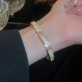 Elegant gold-plated bangle featuring full zircon setting and hollow H-letter design - Gold Letter