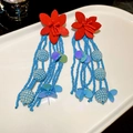 Detail view of red floral stud earrings with blue seed bead tassels on white dish - 10# Silver Needle Floral Round Tassel Earrings