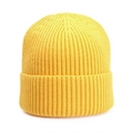 Macro shot of bright yellow ribbed knit beanie showing thick texture and folded cuff - Yellow