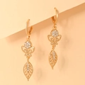 Macro detail of champagne gold butterfly and hollow leaf earrings with white zircon stones - EH087 Butterfly Hollow Leaf Style