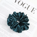 Elegant emerald green silk satin scrunchie with large pleats on a fashion magazine - Dark Green