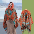 Ethnic hooded poncho with orange patterns and fringes shown on model and flat lay - 140x159cm / Blue and Orange