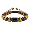 Macro detail of natural tiger eye beads and black woven cord on a handmade bracelet - Letter I