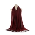 Detailed close-up of wine red cashmere scarf texture with tassel edges on a white background - Burgundy