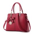 Red pebbled leather handbag for women featuring a bow ornament and golden metal charm - Burgundy