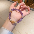 Detail of natural amethyst and citrine beaded bracelet with gold zircon spacers on wrist - Natural Amethyst Citrine Raw Stone Style