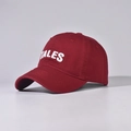 Close-up of TALES 3D white embroidery on a premium burgundy cotton baseball cap fabric - Burgundy