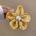 Floral hair scrunchie featuring a yellow velvet flower with center pearl on a clear clip - Yellow Flower Claw Clip