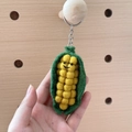 Handmade wool felt corn keychain with a cute smiling face and green outer husk - Auspicious Corn