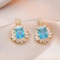 Sparkling gold drop earrings with blue rectangular zircon and floral crystal halo - Blue Rectangular Zirconia Starburst Style (E0776)