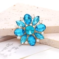 Macro shot of a floral alloy accessory with blue gemstones and white crystals - Lake Blue