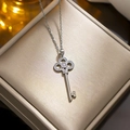Silver titanium steel clover key necklace with diamonds on a golden jewelry box - Four-Leaf Clover Key Pendant Style (8966) / Silver