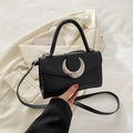 Minimalist black litchi grain leather handbag with silver crescent hardware and crossbody strap - Black
