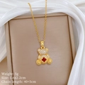 Close-up of gold bear necklace with red clover gemstone pendant in a jewelry box - Pave Zirconia Bear With Red Clover (A518钛钢链条铜微镶吊坠)