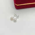 Close-up of natural white freshwater pearl studs with S925 sterling silver butterfly backs - 6mm