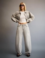 Detail of high-waisted wide-leg denim jeans and cropped jacket in light washed grey - S / Light Gray
