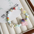 Pastel beaded ceramic bracelet featuring pink shell and starfish charms in jewelry box - 1048-03 Sweet Chestnut