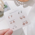 Detailed set of six rose gold stud earrings featuring pearls, stars, and charms for each day - Letter A and Rabbit Style (E0115-1)