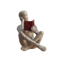 Close-up of reading woman figurine with newsprint texture and red book detail - Reading Woman 01