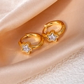 Close-up of gold star hoop earrings with zircon crystals on champagne silk background - Star Zircon / White