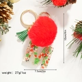 Detailed view of Christmas letter M keychain with red fur ball and green tassel - M
