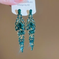 Close-up of emerald green teardrop tassel earrings with golden vintage crystal details - Green Water Drop Tassel (925 Silver Needle)
