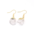 Detailed close-up of natural raw crystal earrings with gold plated hooks and edges - White Crystal