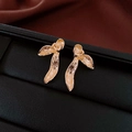 Macro shot of gold floral earrings with textured metal leaves on a black display base - Silver Needle-Gold-Brushed Gold Petal(35#)