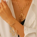 Detail of gold cross pendant necklace and bracelet set with textured finish on model - Gold Bracelet+Necklace (Hollow Cross)