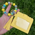 Macro detail of yellow silicone beaded keychain with PU leather card holder and tassel - Yellow