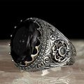 Vintage men's silver ring featuring a large oval black gemstone and intricate carvings - US 7 / Black (AJZ1800)