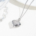 Macro shot of a hollow heart pendant with hammered texture on a silver chain necklace - Quilted Heart Pendant Necklace / Silver