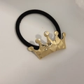 Elastic hair tie with a geometric golden crown ornament on a simple black band - Crown Gold