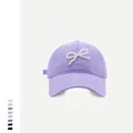 Detailed view of the pearl bow embellishment on a lilac cotton baseball cap crown - M (56-58cm) / Light Purple