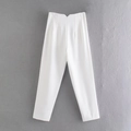 Detail of white high-waisted trousers featuring a V-shaped cut and pleated waist design - XS / Bottoms / Off White