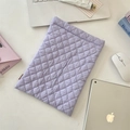 Flat lay of soft lavender quilted laptop sleeve with stylish office accessories - Light Purple