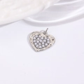 Macro shot of a silver-tone heart pendant featuring embedded faux white pearls - Pearl Inlay Heart Pendant / Silver