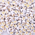 Macro view of white acrylic round beads with golden cross patterns for DIY jewelry making - 4x7mm Gold Cross (100pcs)