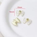 Detail view of 17mm x 15mm resin bow pendant with gold heart for DIY jewelry - Style 38