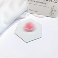 Macro shot of fluffy pink faux mink fur pompom accessory on marble display base - Light Pink
