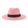 Detail of pink straw Panama hat with black ribbon band on a clean white background - Pink