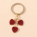 Minimalist golden keychain featuring three red sparkling heart charms for handbags - Small Heart / Red