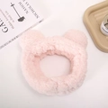 Detailed close-up of a pink plush headband with cute bear ears for skincare routine - Bear Hairband / Pink